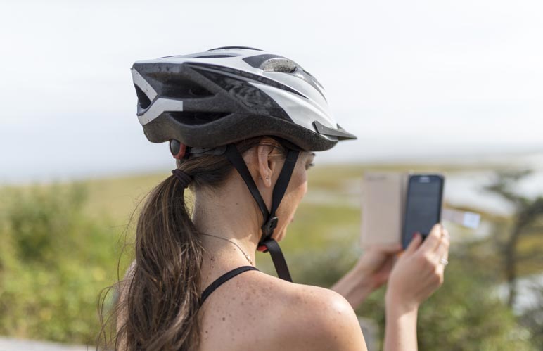 A woman wearing a biking helmu