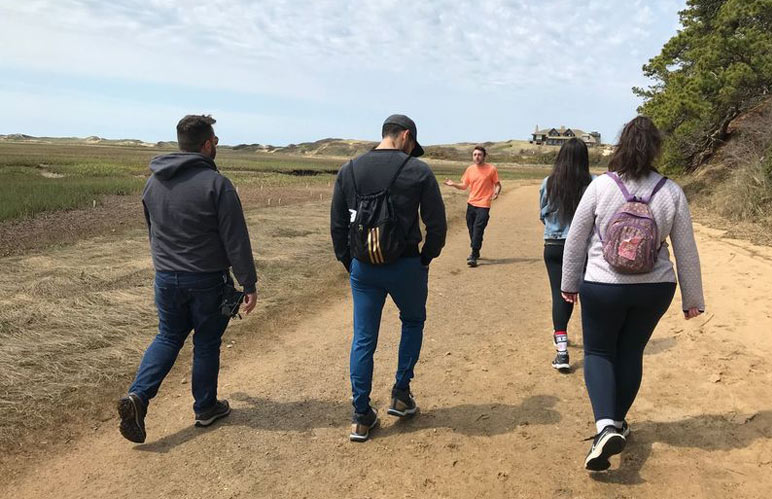 Group of hikers in beach-side dunes