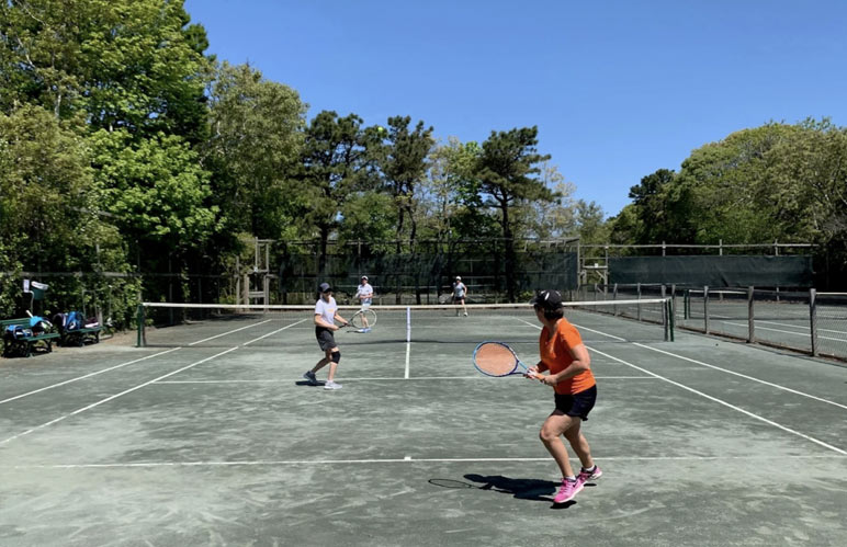 Tennis doubles playing on a tennis court.